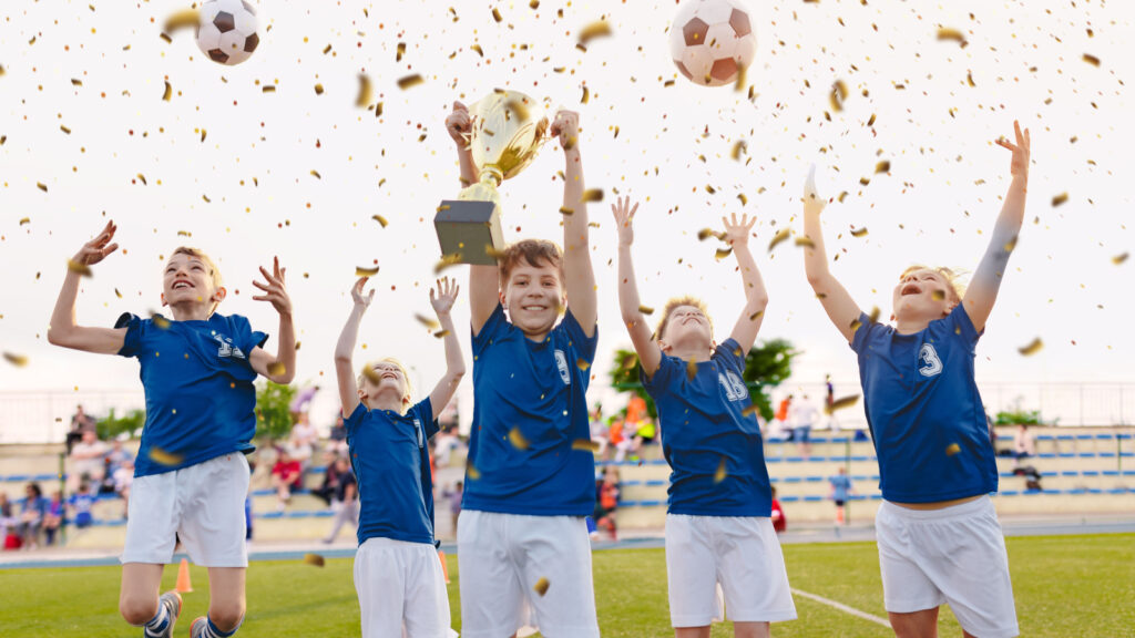 Athletes holding youth sports awards after a championship game