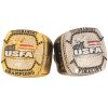 Two USFA rings: gold for tournament champions, silver for finalists, adorned with intricate detailing and logos.