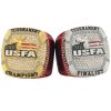 Close-up of USFA championship and finalist rings with intricate designs.